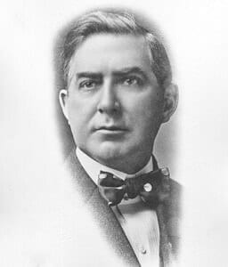 Portrait of a distinguished man in 19th-century attire, historical museum exhibit showcasing early American history.