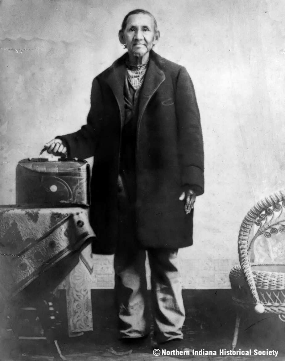 Pokagon ph 3437 resize Old man with vintage suitcase and walking cane, historical photograph from the 19th century.