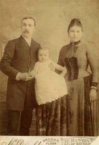Family portrait of a man, woman, and a baby, vintage photograph.