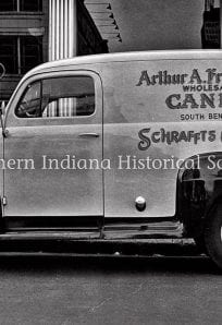 Vintage delivery truck advertising Arthur A. Fredrickson wholesale candy and Schrafft's chocolates in Indiana, black and white historic photo.
