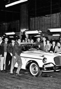 1950s vintage car exhibit at The History Museum in Northern Indiana, with a group of people admiring classic automobiles.