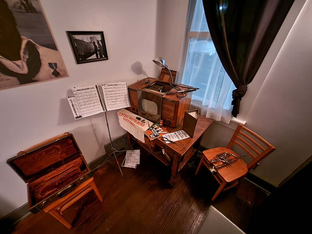 Vintage radio and sheet music display in The History Museum room.