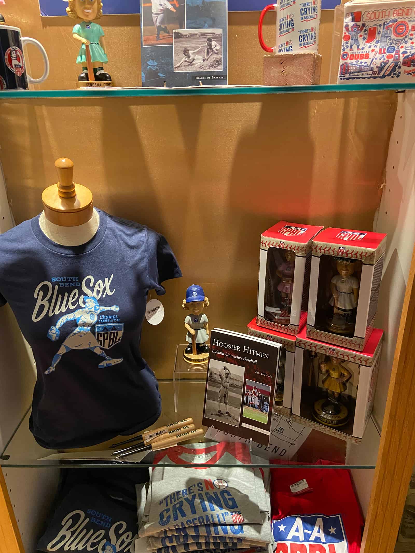 Kenosha Comets vintage memorabilia display with baseball-themed merchandise and historical photos.