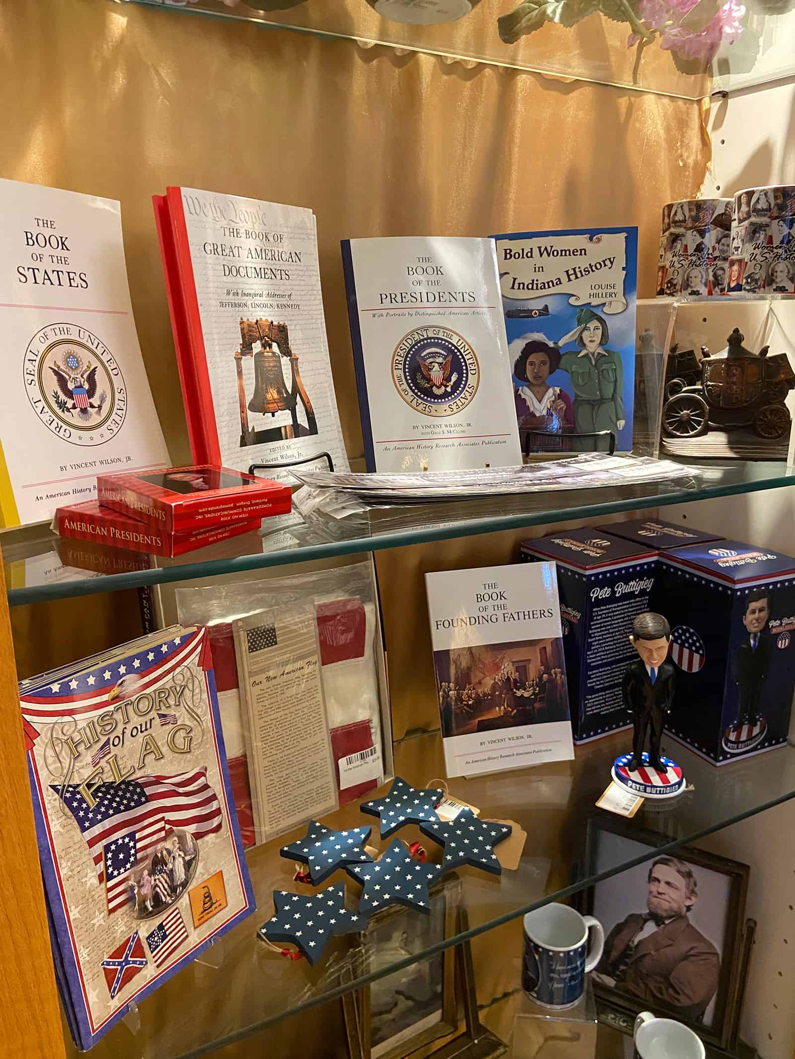 History museum display showcasing American history books, patriotic memorabilia, and historic items.