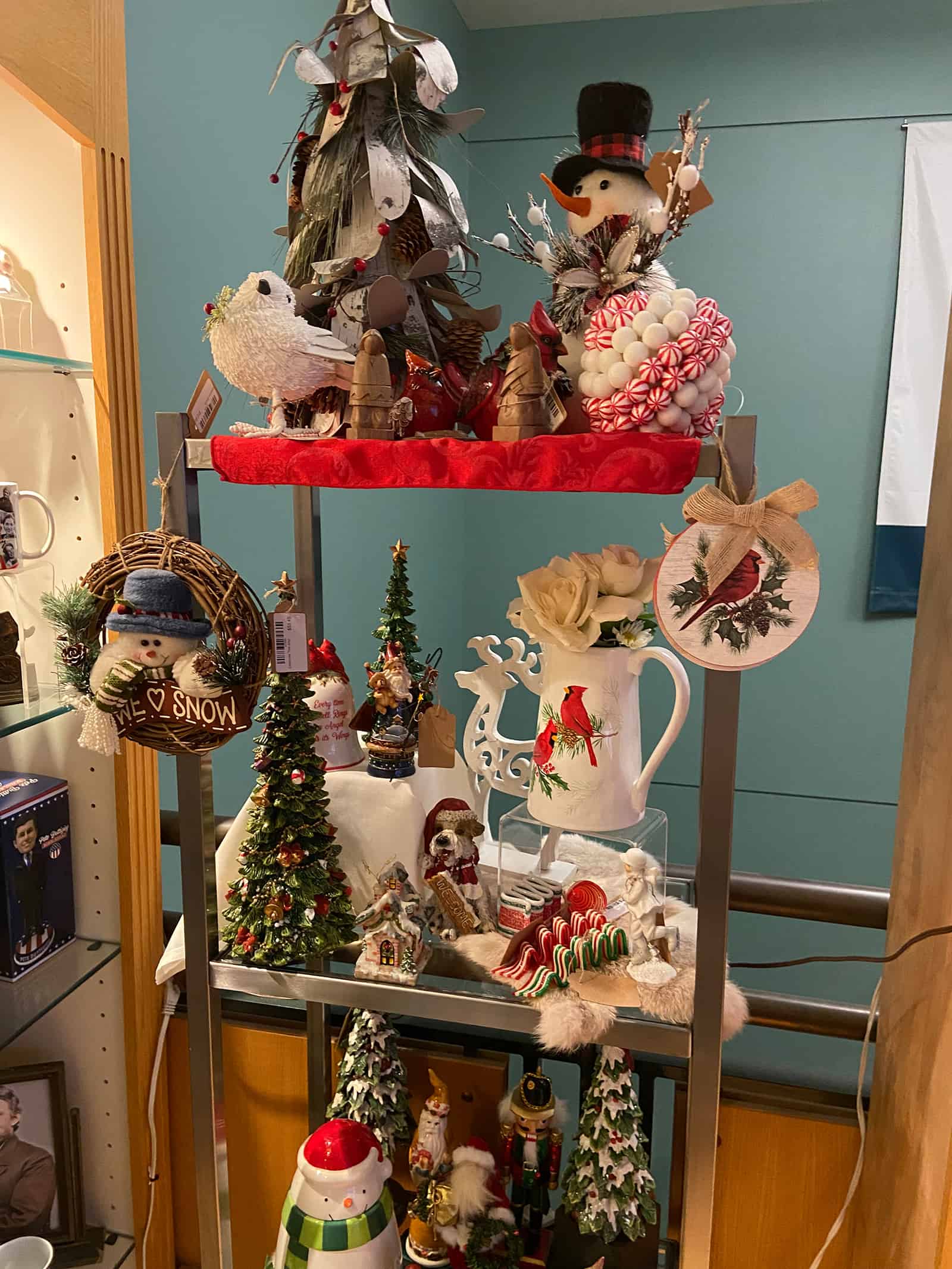 Colorful Christmas decorations, including snowmen, Christmas trees, and holiday figurines in a festive display.