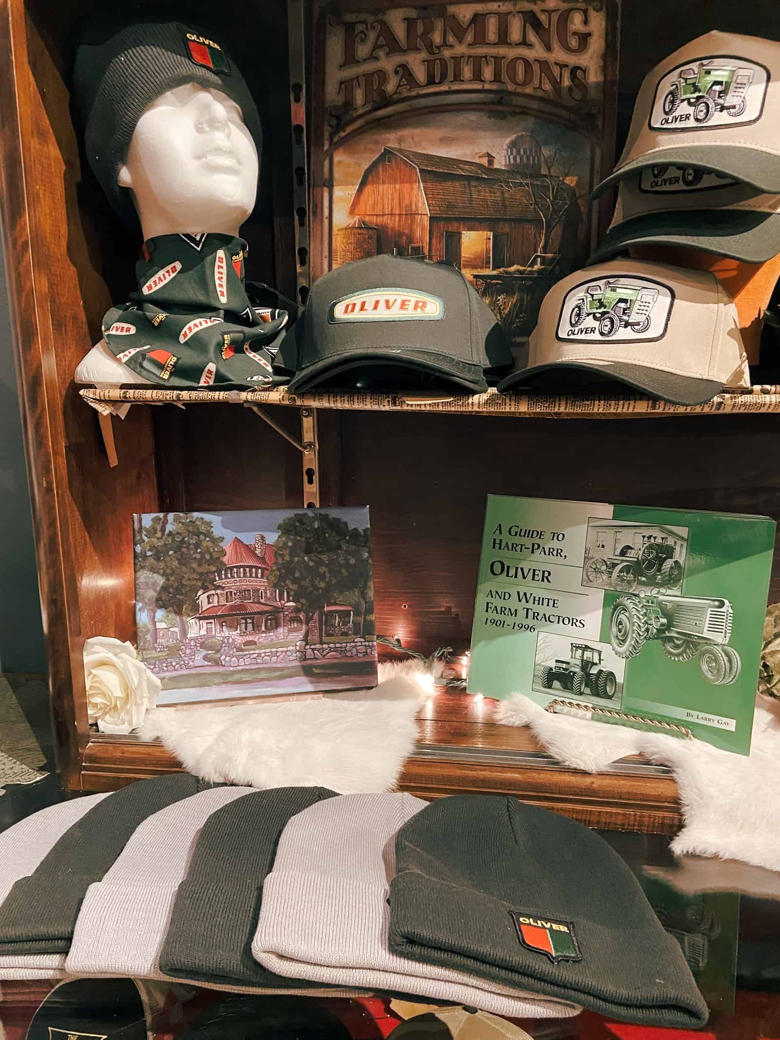 Beanie hat with "OLIVER" logo and tractor-themed baseball caps at The History Museum.
