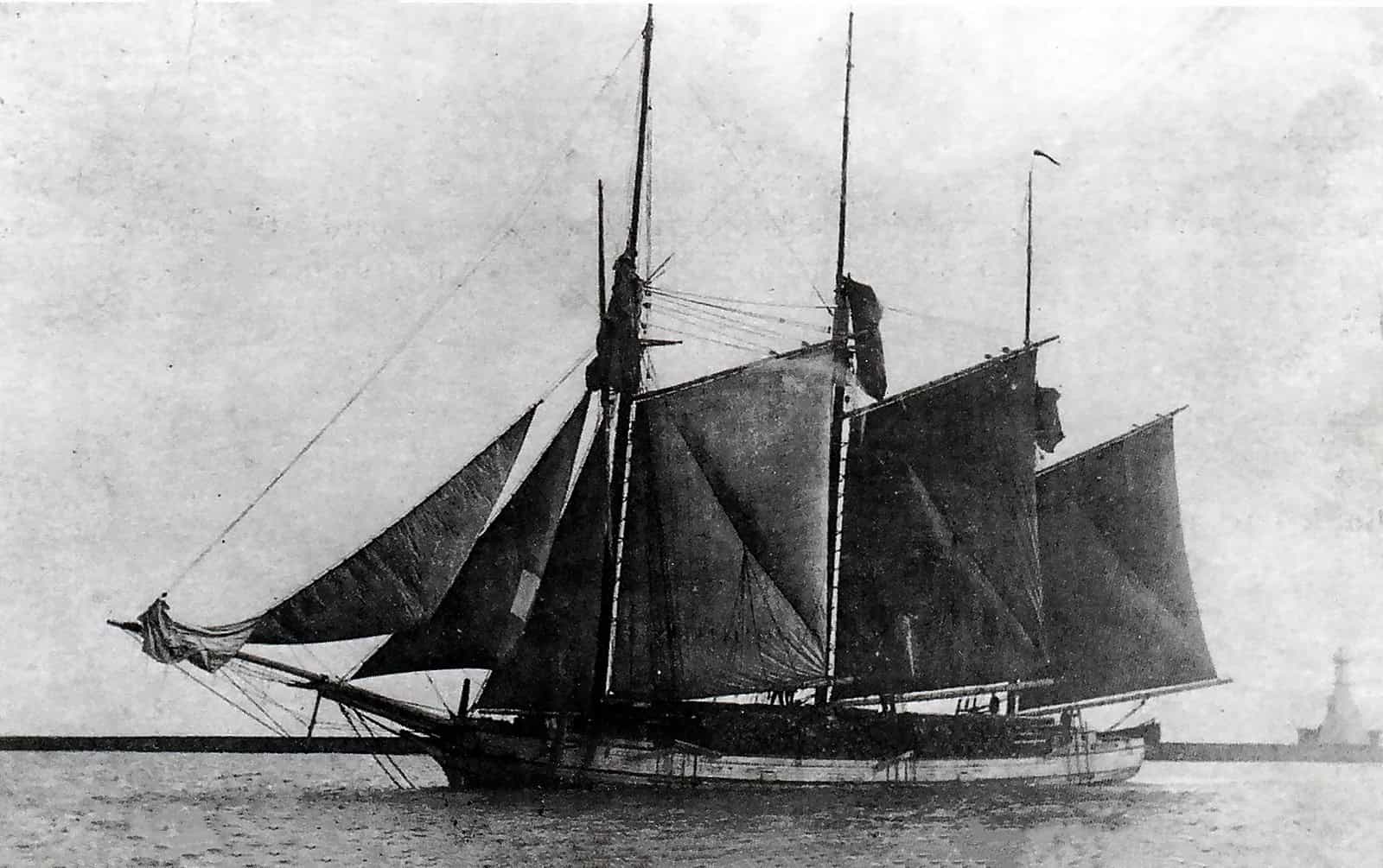 Sailing ship with multiple masts and sails in vintage black and white photo, historic maritime vessel, old sailing ship on water, maritime history, the history museum focus.