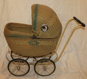 CSH02Buggy Antique woven wicker doll stroller with metal wheels, vintage toy from the early 20th century.