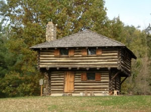 Log cabin historical museum exhibit showcasing early American frontier architecture and cultural history.