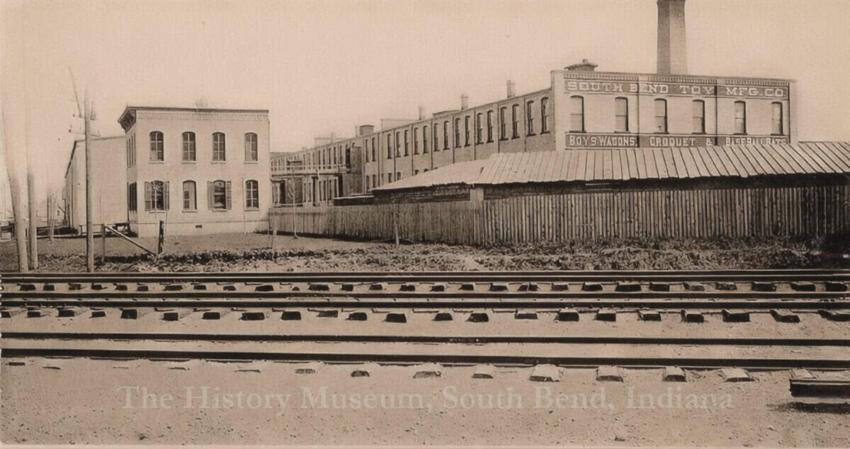 SBToyPH 17061_WM South Bend Toy Manufacturing building in historic South Bend, Indiana, with nearby railroad tracks, showcasing early industrial architecture.