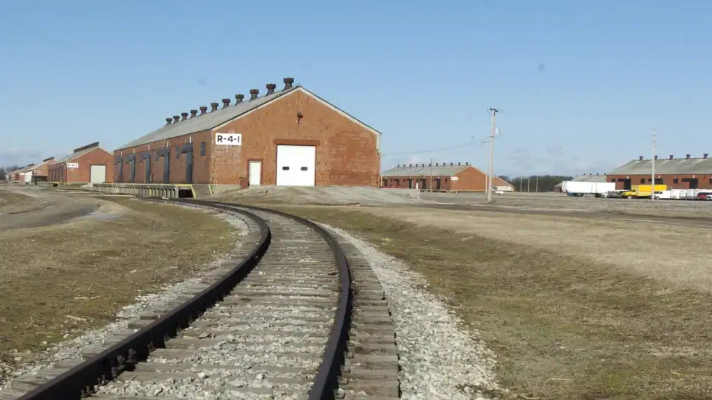 Kingsbury Tracks leading to historic brick buildings at The History Museum, showcasing early 20th-century industrial architecture and railroad history.