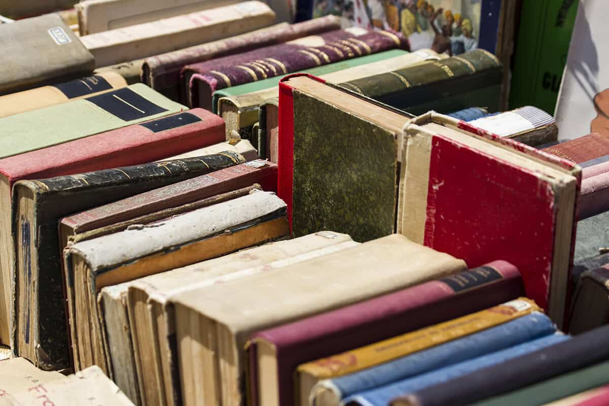 Vintage books collection at The History Museum, old hardcover books, historical library items, archival books for history enthusiasts.